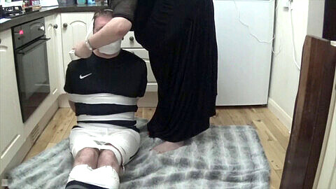 Football player restrained and gagged, wearing tight duct tape outfit
