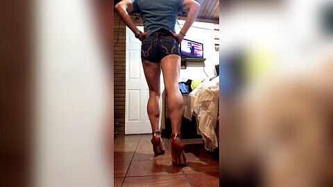 Seductive muscle tease in denim shorts and high-heeled sandals that show off those legs!
