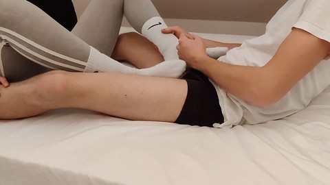 Naughty girl treats him to a sockjob instead of Christmas presents, lets him cum on her juicy booty in grey leggings