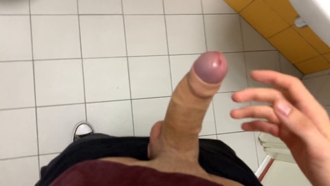 Risky bathroom fun: Hot guy jerks off at the gym and narrowly avoids getting caught!