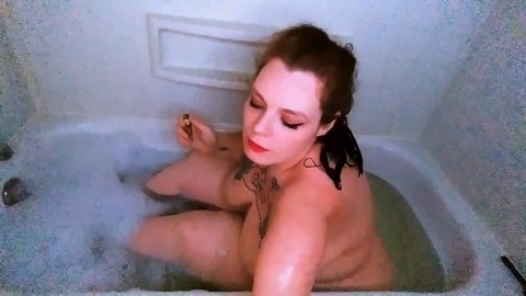 Curvy babe enjoys a smoke in the tub