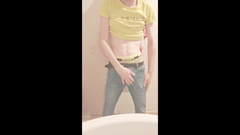 Slim guy jerks off in the bathroom, satisfying his cravings for self-pleasure