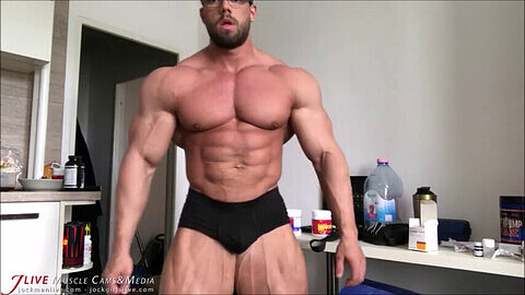 Beefcake bodybuilder flexes his massive muscles in a hot muscle worship session