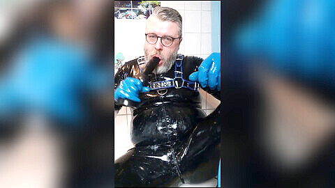 Hardcore rubber fetish - choking, spitting and deepthroating a massive dildo