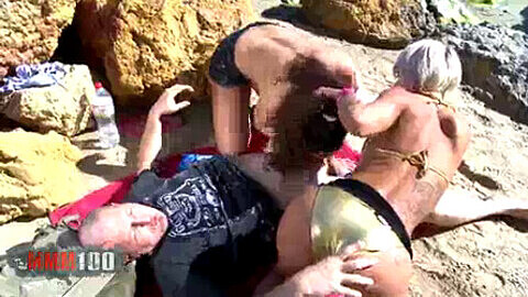 Steamy threesome action on a crowded Spanish beach