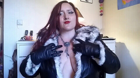Leather-clad mistress savors the sensual feel of her gloves
