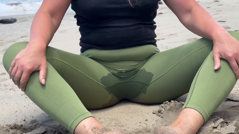 Milf practices yoga on beach and wets her pants for a thrilling public experience