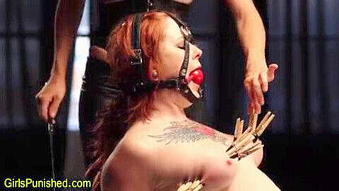 Submissive lesbian is completely immobilized and dominated with ballgag, clamps, and cane